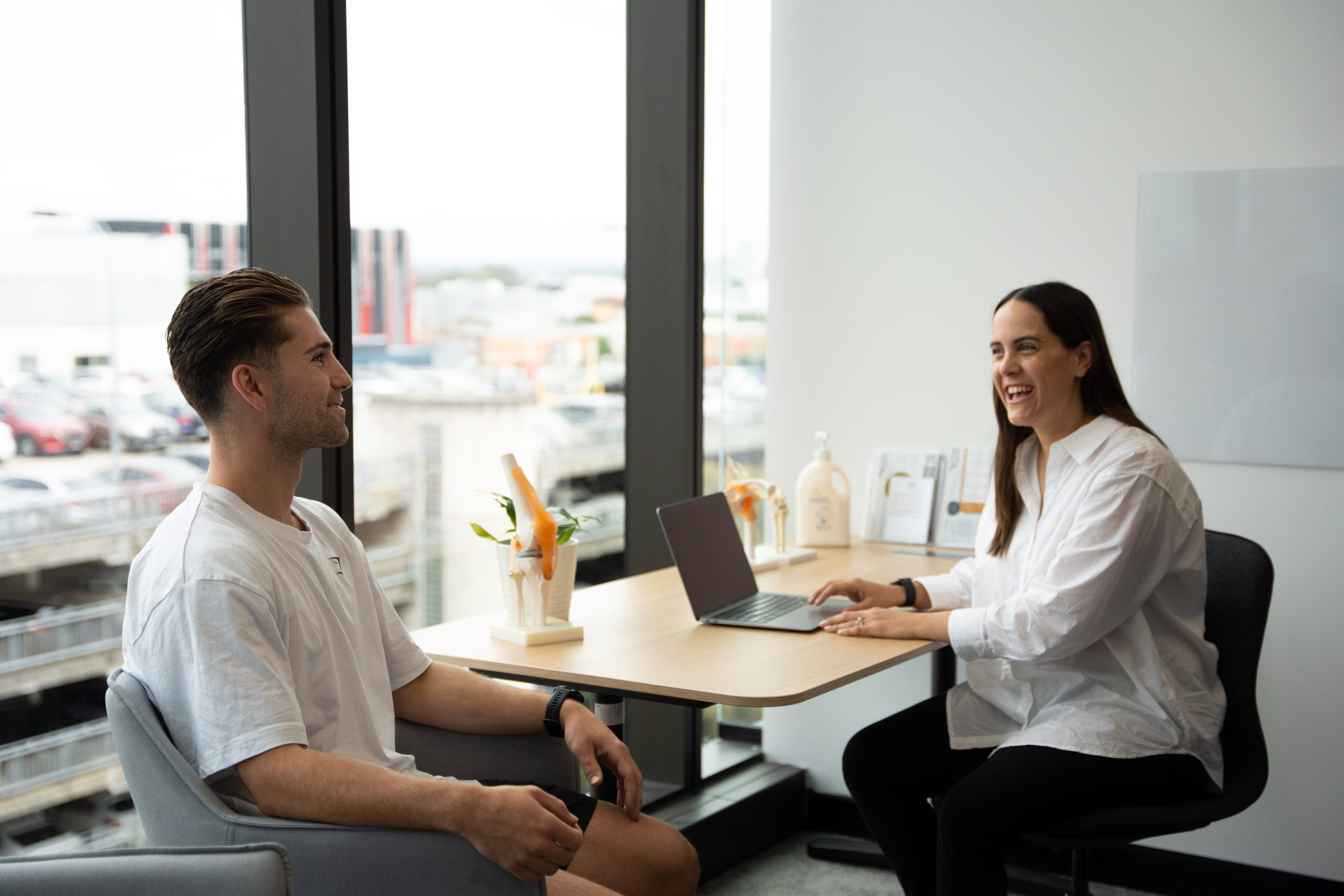 MTP Health clinician consulting with a patient beside a knee model